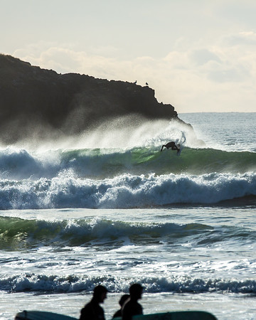 Surfer riding a wave off the coast of Tofino, British Columbia